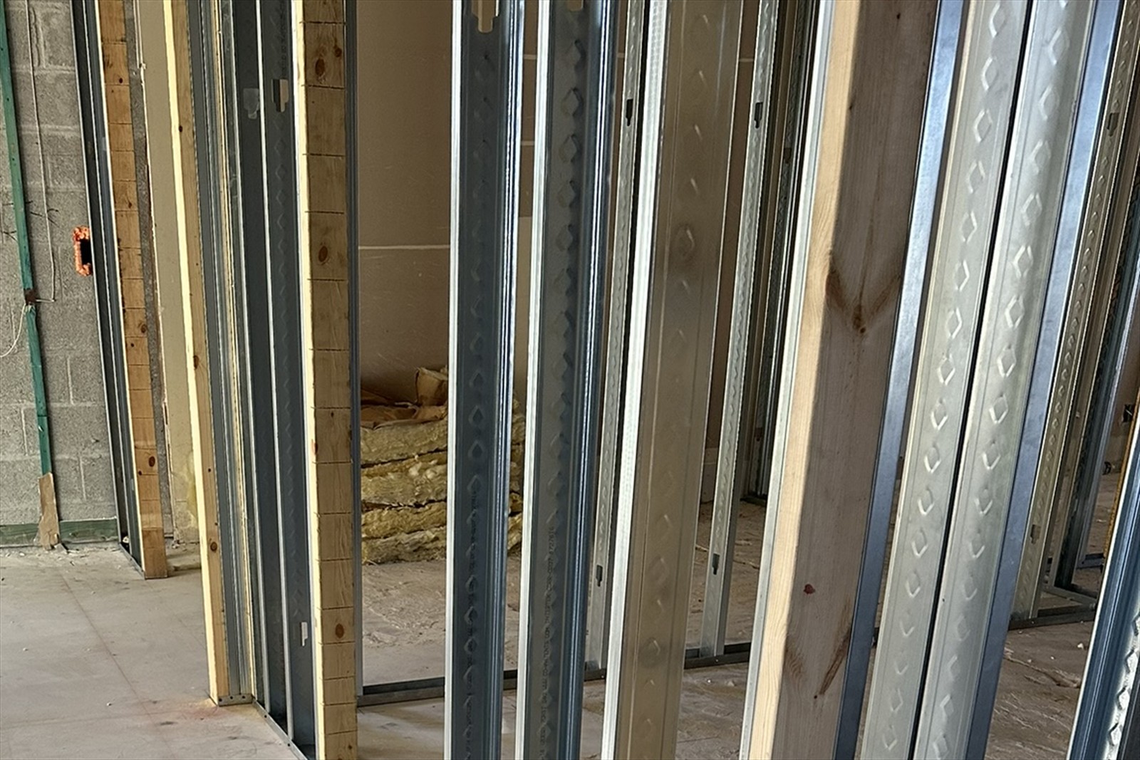 Basement restoration project with framing and concrete floor preparation